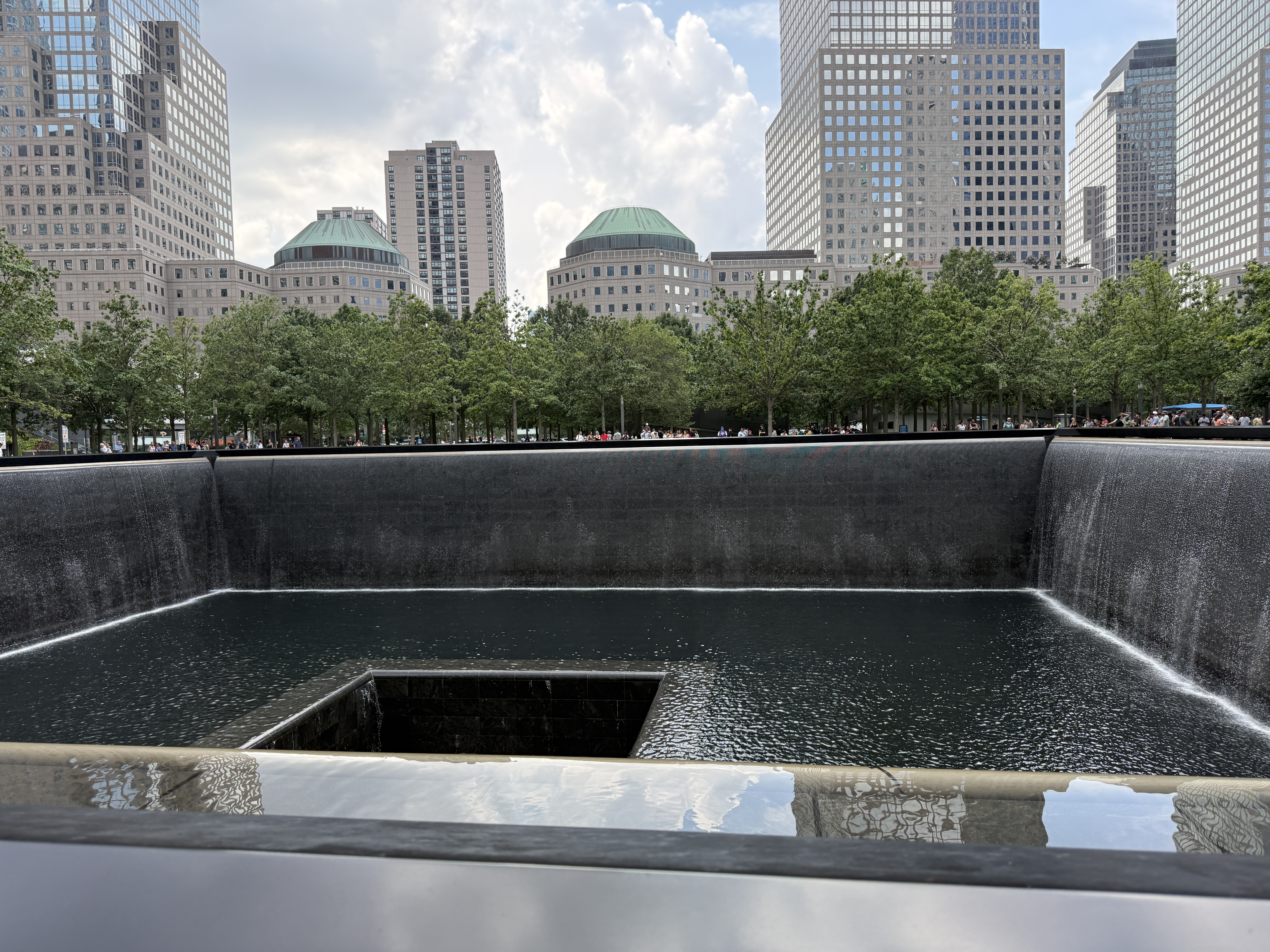 One of the reflecting pools at the 9/11 Memorial with names inscribed on the bronze parapet