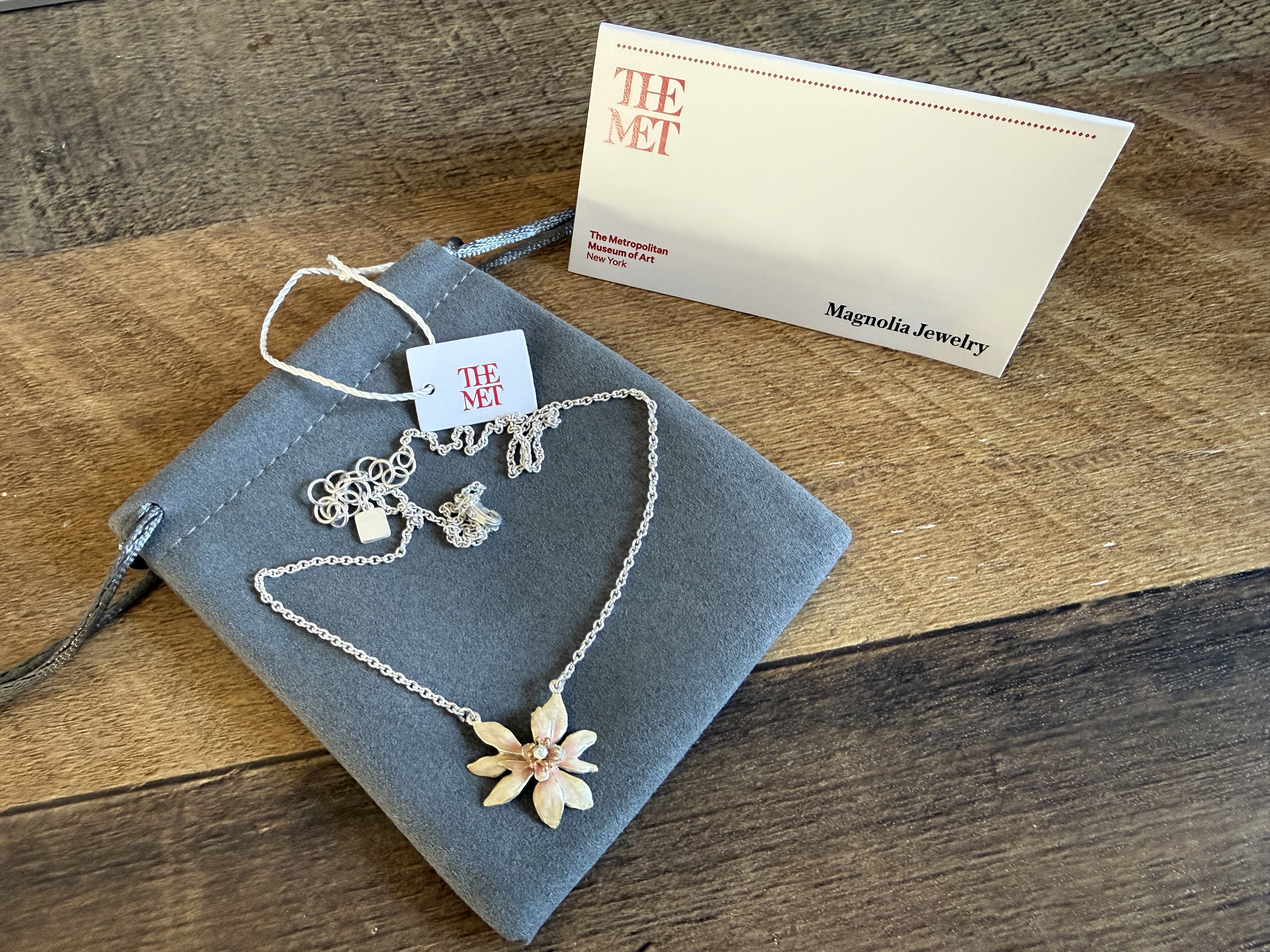 An enameled magnolia pendant necklace from The Met