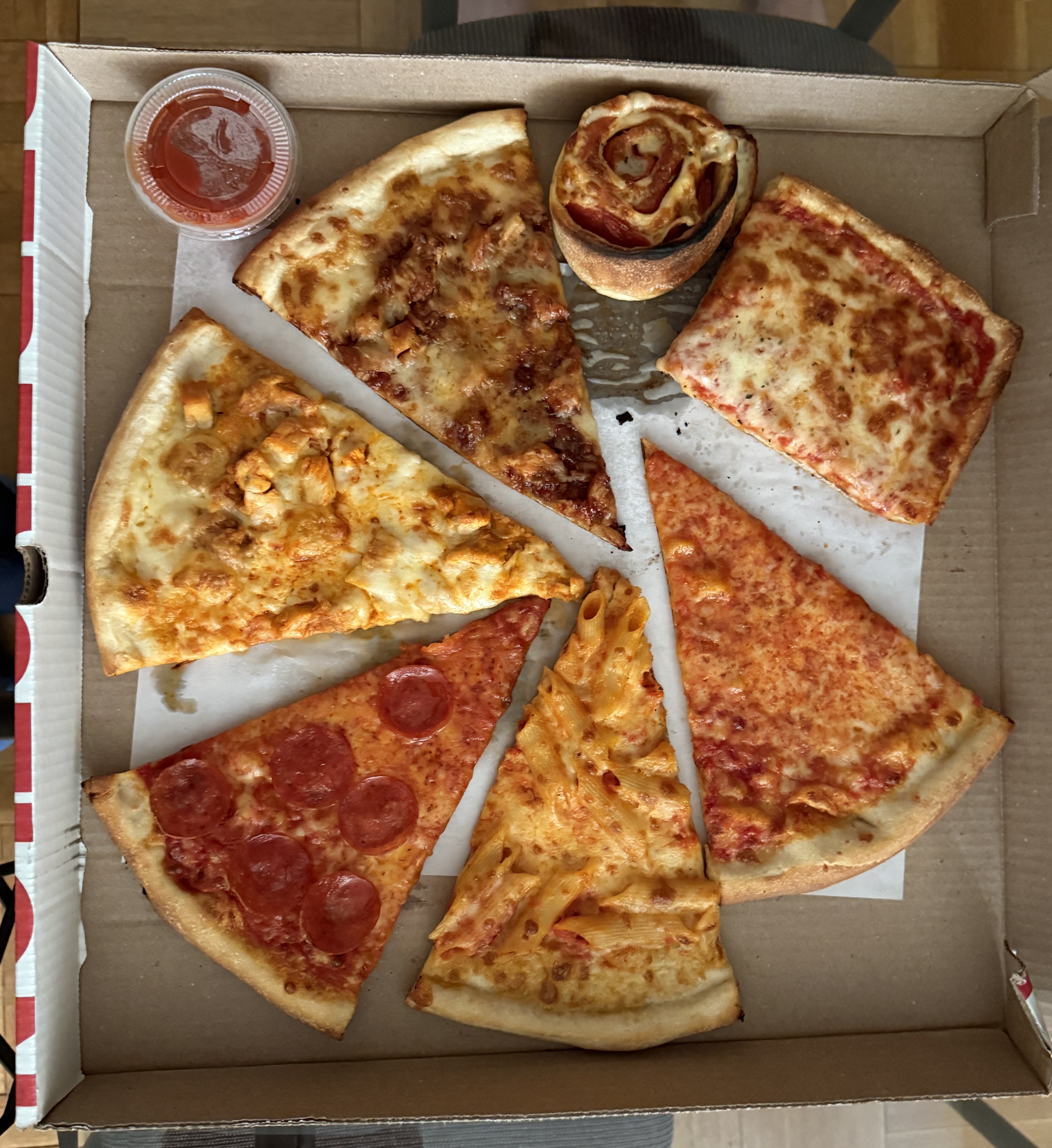 Six different slices of New York pizza laid out on a table