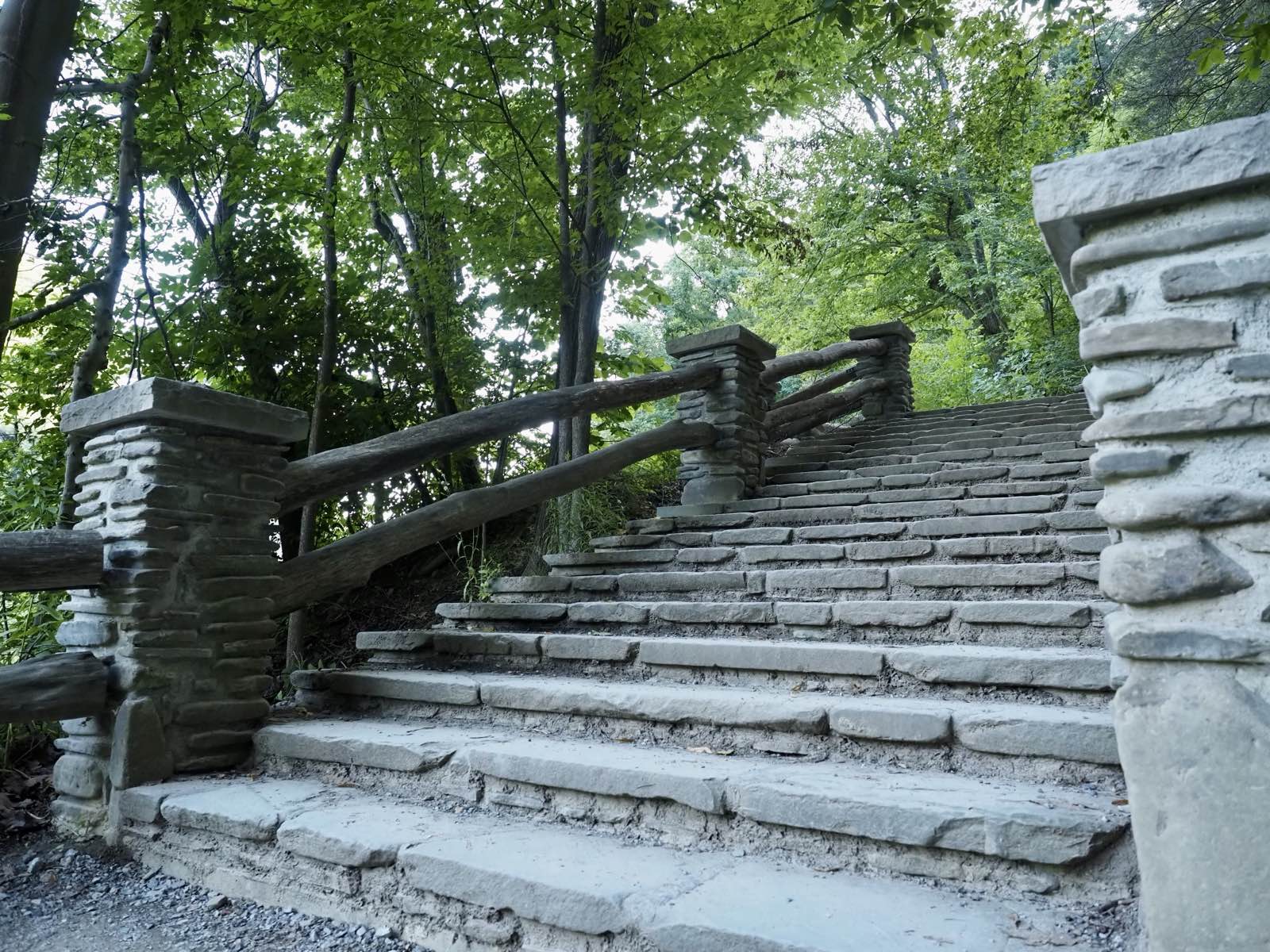 Hand-laid stone stairs winding down through the trees at Letchworth.