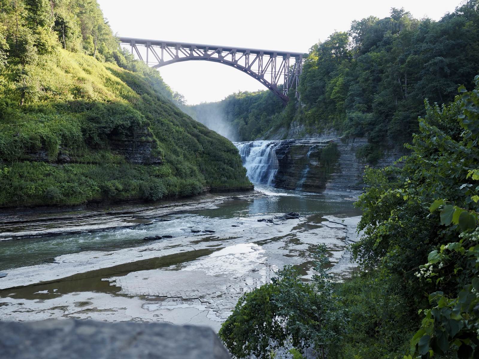 The Genesee Arch Bridge spanning the gorge with Upper Falls pouring underneath it.